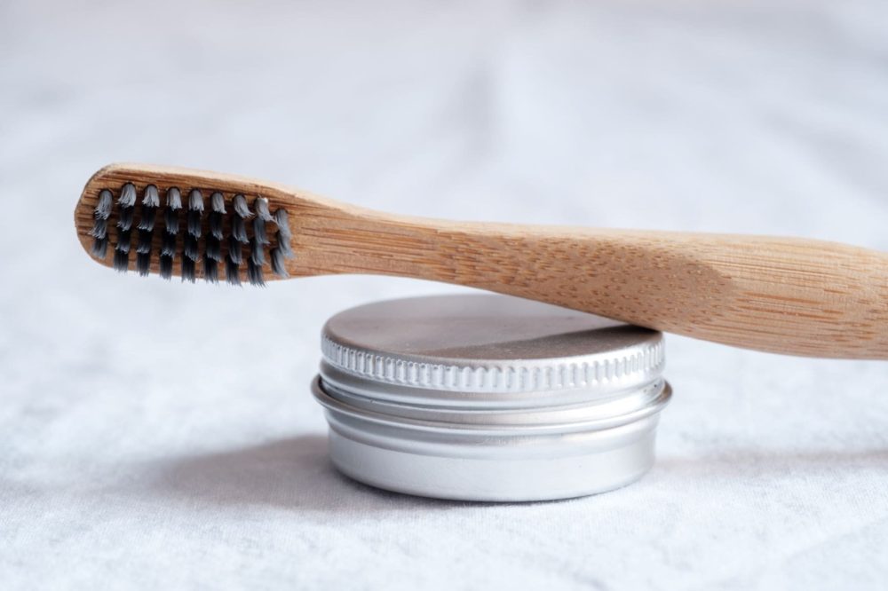 homemade toothpaste and a bamboo toothbrush