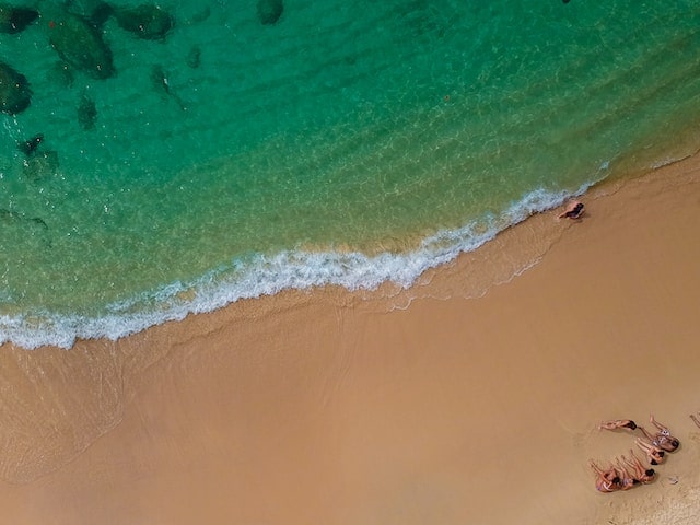 People enjoying the sun by the beach